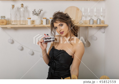 Very beautiful and cheerful woman holding cakes in 45852559