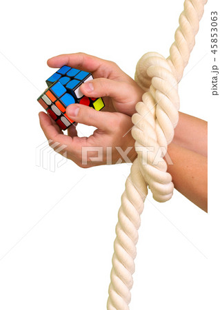 Cube puzzle with bandaged hands with a rope Cube puzzle with bandaged hands with a rope 45853063