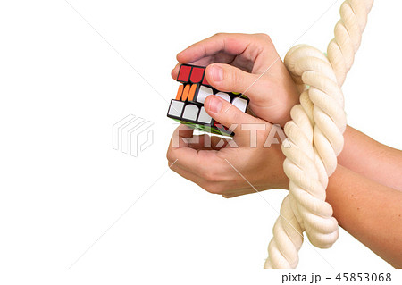 Cube puzzle with bandaged hands with a rope Cube puzzle with bandaged hands with a rope 45853068