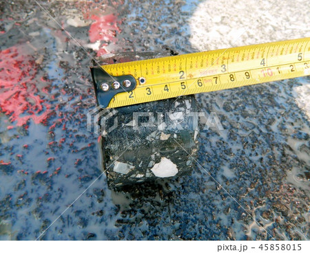 Asphaltic concrete floor thickness measured  45858015