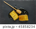 honeycomb and honey stick on a black 45858234