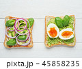Two avocado toasts on white wooden background 45858235