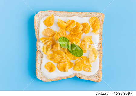 Cornflakes on Yogurt on Bread on Blue Pastel BG Cornflakes on Yogurt on Bread on Blue Pastel BG 45858697