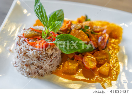 duck confit with red curry served with brown rice on plate duck confit with red curry served with brown rice on plate 45859487