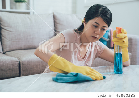 asian woman using sprayer rag. asian woman using sprayer rag. 45860335