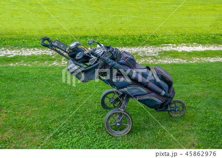 Golf bag with clubs on roller stand on golf course 45862976