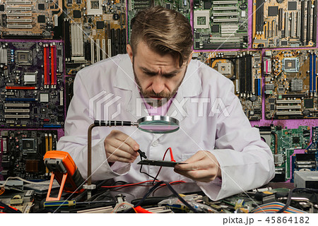 Young radio electronics engineer in laboratory Young radio electronics engineer in laboratory 45864182