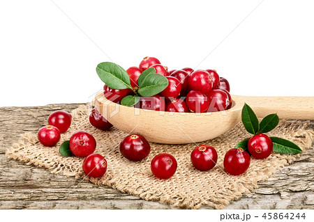 Cranberry with leaf in wooden spoon on old wooden table with white background 45864244