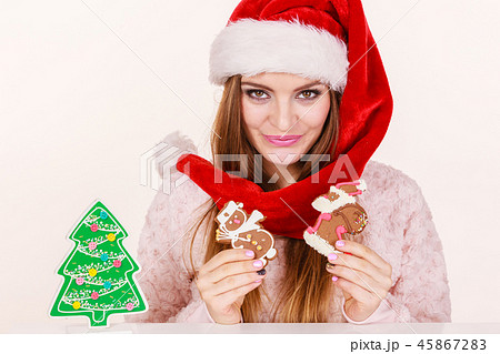 Woman santa claus hat with gingerbread cookies. Christmas 45867283