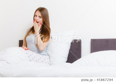 Young girl yawning. 45867294