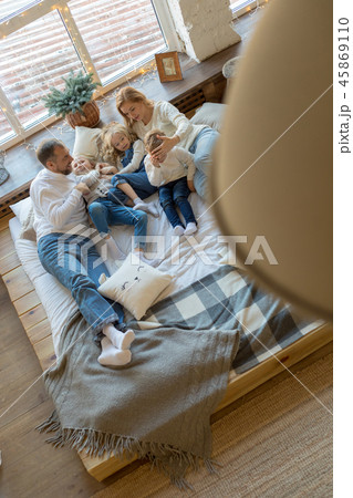 Happy family is lying on the bed and having fun. Happy family is lying on the bed and having fun. 45869110