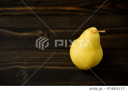Yellow ripe fresh pear on old wooden board 45869137