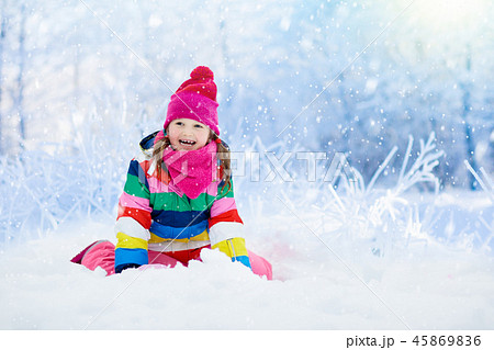 Child playing with snow in winter. Kids outdoors. Child playing with snow in winter. Kids outdoors. 45869836