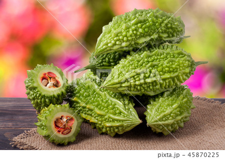 heap of bitter melon or momordica on wooden table with blurred background heap of bitter melon or momordica on wooden table with blurred background 45870225