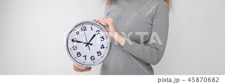 Charming young girl with red hair. A young girl in a gray sweater. Young girl on a gray background 45870682