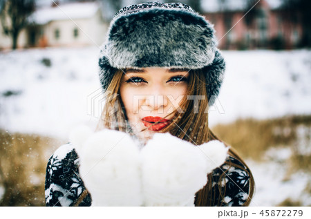Young woman blowing snow 45872279