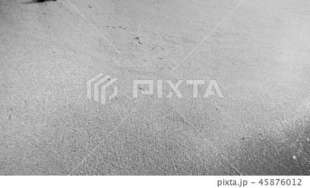 Black and white closeup image of wet sand on ocean beach Black and white closeup image of wet sand on ocean beach 45876012