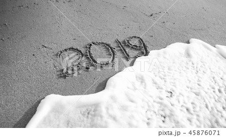 Black and white image of 2019 New Year numbers written on sea beach. Concept of celebrations Black and white image of 2019 New Year numbers written on sea beach. Concept of celebrations 45876071