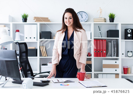 Portrait of the waist of a young girl in a bright office. Portrait of the waist of a young girl in a bright office. 45876625