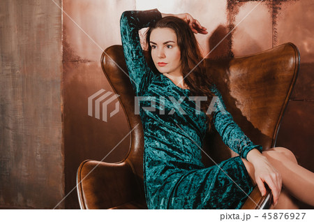 Beautiful woman in velvet dress, sitting in chair 45876927