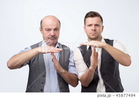 Two mature men giving showing time out hands gesture 45877494