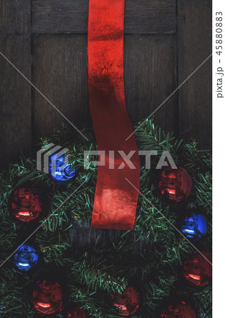 Christmas wreath on the door of a wooden house Christmas wreath on the door of a wooden house 45880883