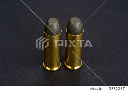 The .45 caliber revolver cartridges on black The .45 caliber revolver cartridges on black 45882287