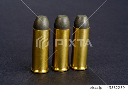 The .45 caliber revolver cartridges on black The .45 caliber revolver cartridges on black 45882289