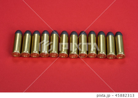 The .45 caliber revolver cartridges on red  45882313