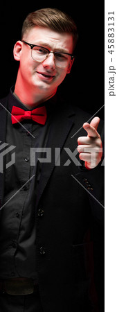 Portrait of confident handsome elegant responsible businessman pointing at camera on black Portrait of confident handsome elegant responsible businessman pointing at camera on black 45883131