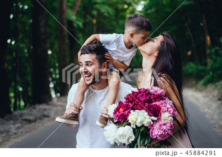 Young parents are walking in the park with their little son. Young parents are walking in the park with their little son. 45884291