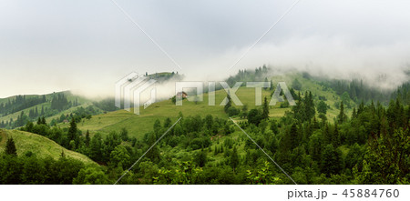Little house on a green mountain slope 45884760