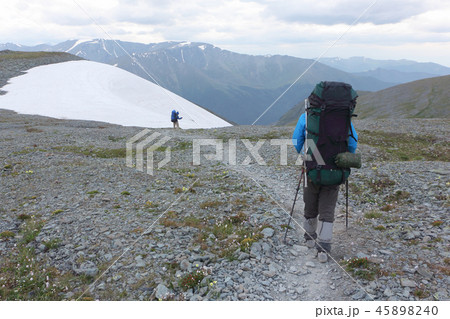 Tourist man coming down from the PassKara-Turek Tourist man coming down from the PassKara-Turek 45898240