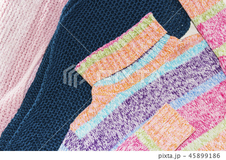 Knitted wool sweaters. Pile of knitted  45899186
