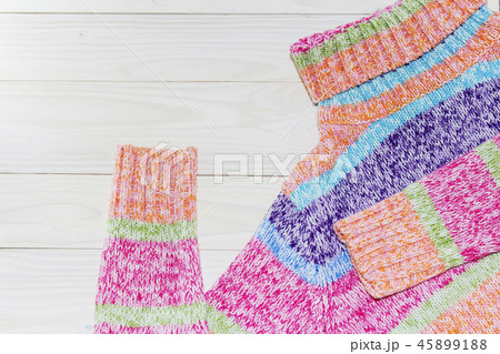 Knitted wool sweaters. Pile of knitted winter 45899188