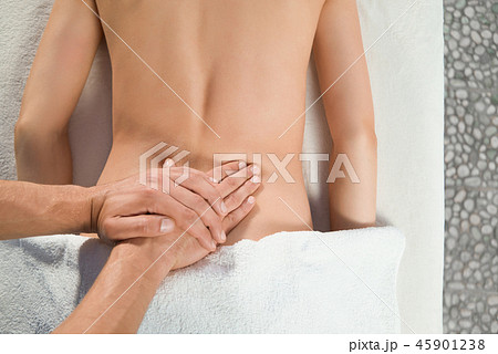 View from above of hands of masseur doing back massage 45901238