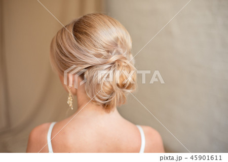 Rear view of female hairstyle middle bun with blond hair 45901611
