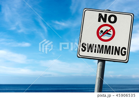 No Swimming - Sign on a Blurred Blue Sea No Swimming - Sign on a Blurred Blue Sea 45906535