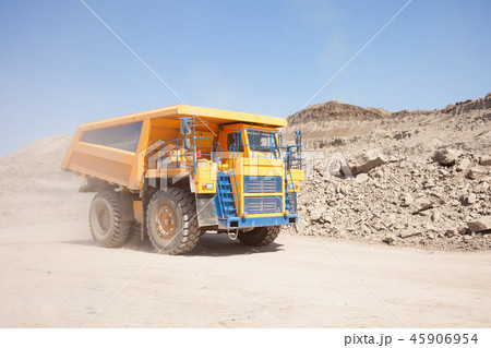 Yellow dump truck moving in a mine 45906954