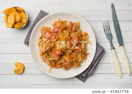 Stewed cabbage with sausages in a plate Stewed cabbage with sausages in a plate 45907758