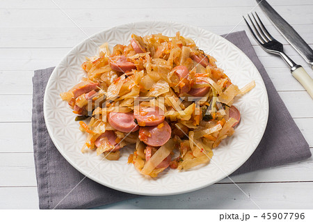 Stewed cabbage with sausages in a plate Stewed cabbage with sausages in a plate 45907796