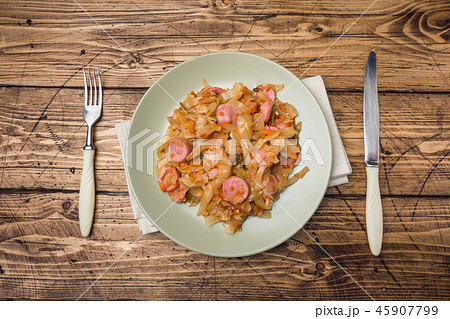 Stewed cabbage with sausages in a plate Stewed cabbage with sausages in a plate 45907799