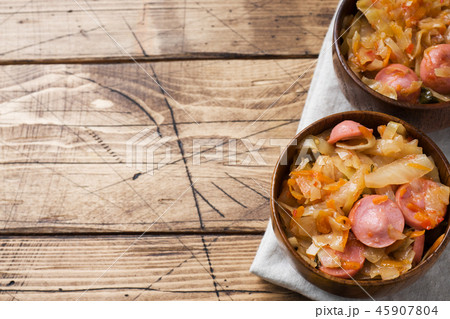 Stewed cabbage with sausages in a plate Stewed cabbage with sausages in a plate 45907804