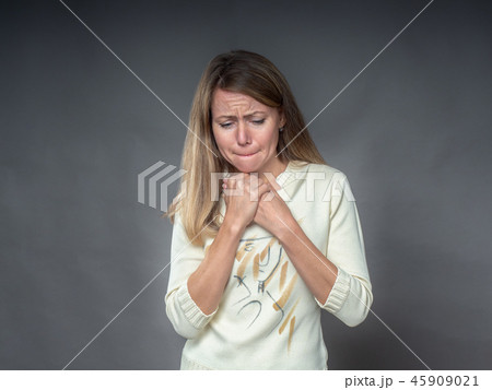 Woman with hands on his chest sorrowfully with Woman with hands on his chest sorrowfully with 45909021