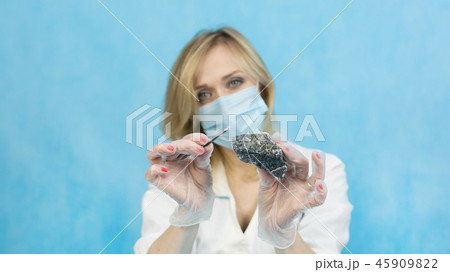 The girl laboratory technician examines samples 45909822