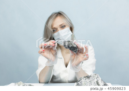 The girl laboratory technician examines samples 45909823