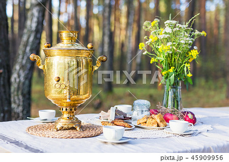 Table with russian samovar, cups decorated with some flowers 45909956