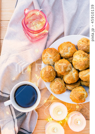 Сoffee table served with coffee, sweet cookies decorated with candles and lights 45910139