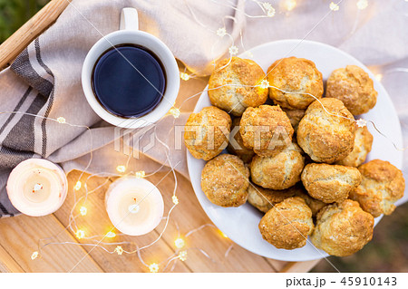 Сoffee tray laid with coffee cup, cookies and candles outdoors. Top view. 45910143