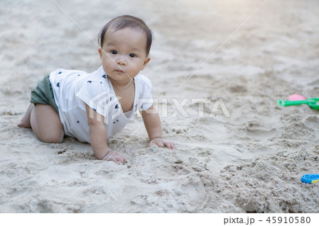 Asian toddler baby thai girl playing with sand 45910580